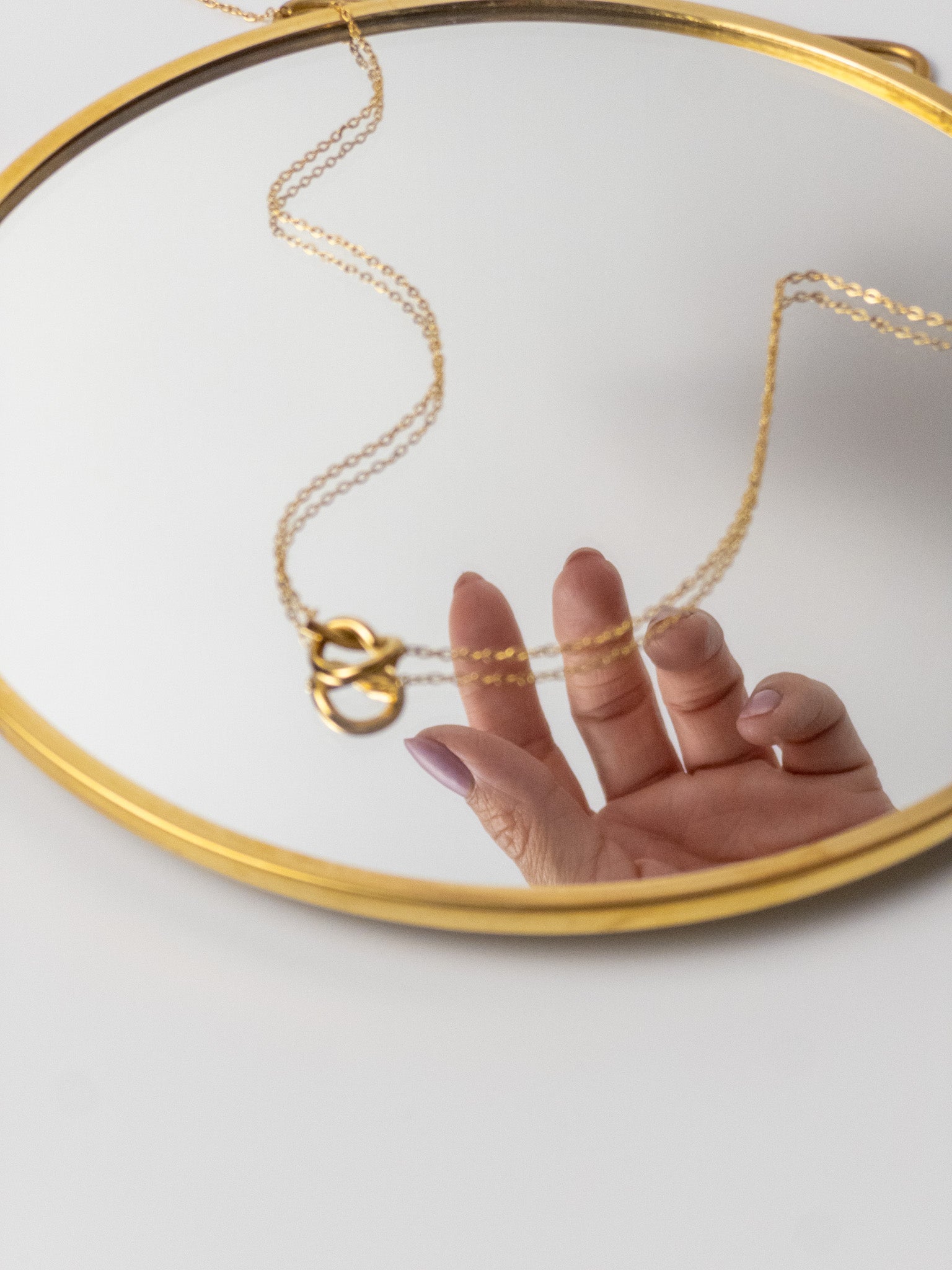 Minimal gold heart necklace styled for elegant everyday wear