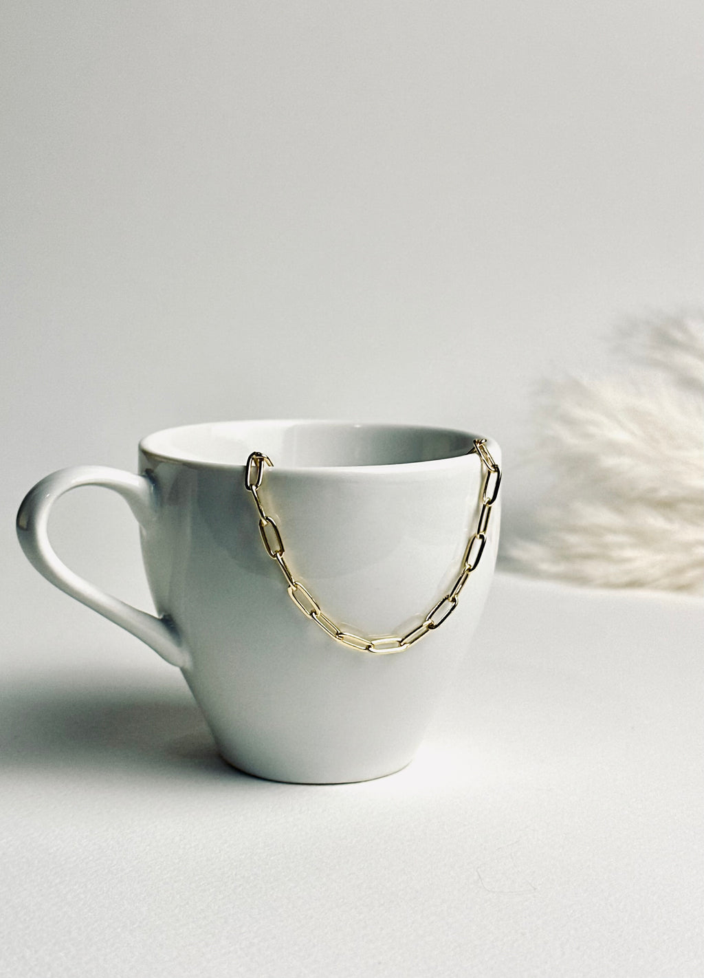 Gloria – Gold Paperclip Necklace from the Timeless Grace collection, an 18k gold-filled 16-inch chain. The delicate links catch the light, reflecting timeless elegance and quiet confidence — a reminder to carry your grace with ease and let your inner glow shine.