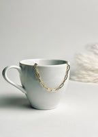 Gloria – Gold Paperclip Necklace from the Timeless Grace collection, an 18k gold-filled 16-inch chain. The delicate links catch the light, reflecting timeless elegance and quiet confidence — a reminder to carry your grace with ease and let your inner glow shine.