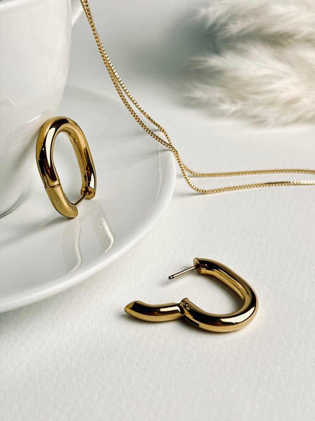 Vera Hoop earrings from the “Timeless Grace” collection displayed side by side — one open and one closed — highlighting their sturdy clasp and smooth 18k gold-plated finish. A modern, timeless design that balances elegance with everyday strength.