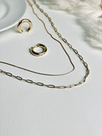 Radiance Hoop earrings from the “Timeless Grace” collection paired with layered gold necklaces. The 20mm thick hoops harmonize with the delicate layers, creating a look of effortless elegance, confidence, and timeless sophistication.