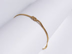Grace Knot Bracelet gold infinity knot bracelet angled view on white background