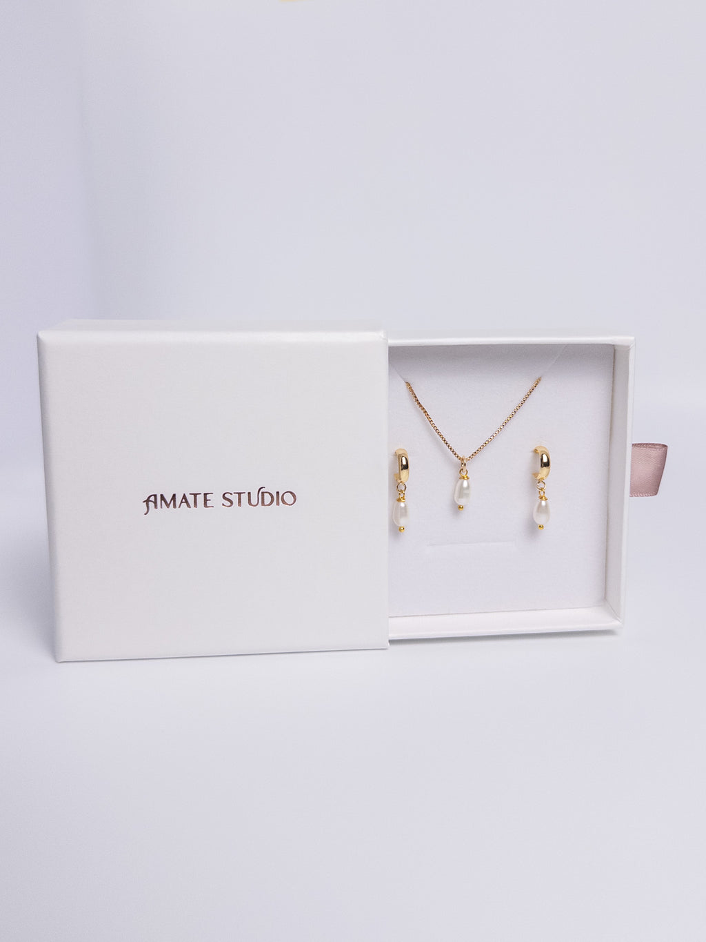 Pearl Harmony Gift Set with gold drop earrings and single pearl necklace flat lay view