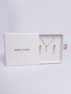 Pearl Harmony Gift Set with gold drop earrings and single pearl necklace flat lay view