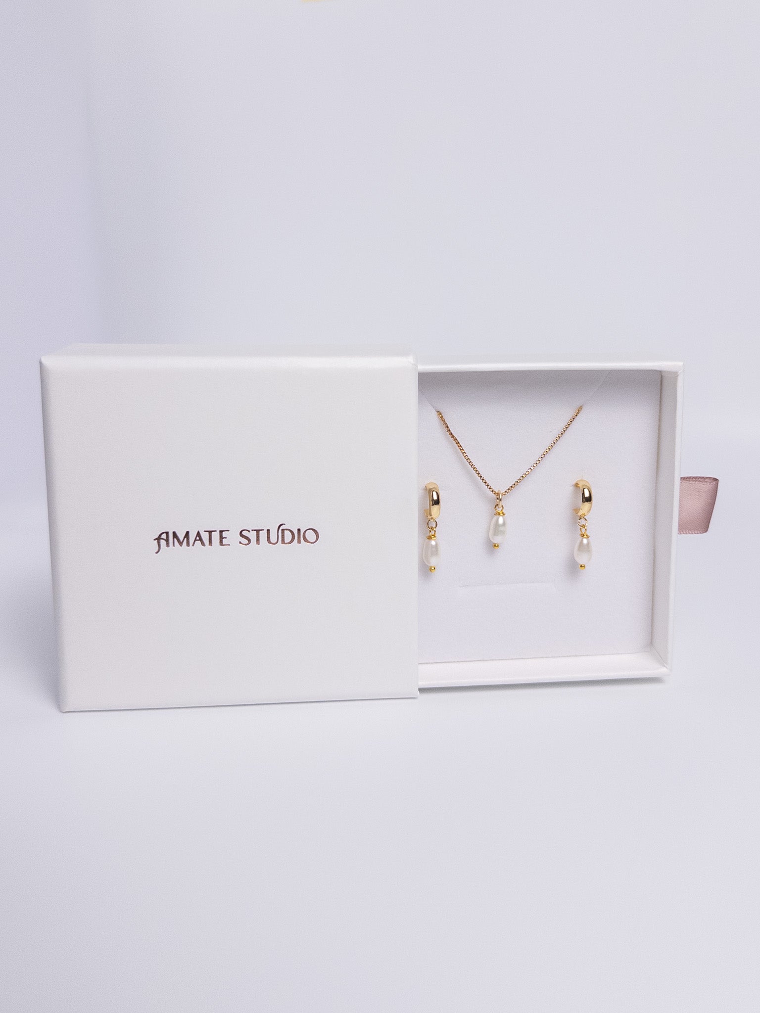 Pearl Harmony Gift Set with gold drop earrings and single pearl necklace flat lay view