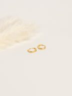 Grace Thread gold rope hoop earrings flat lay on white background