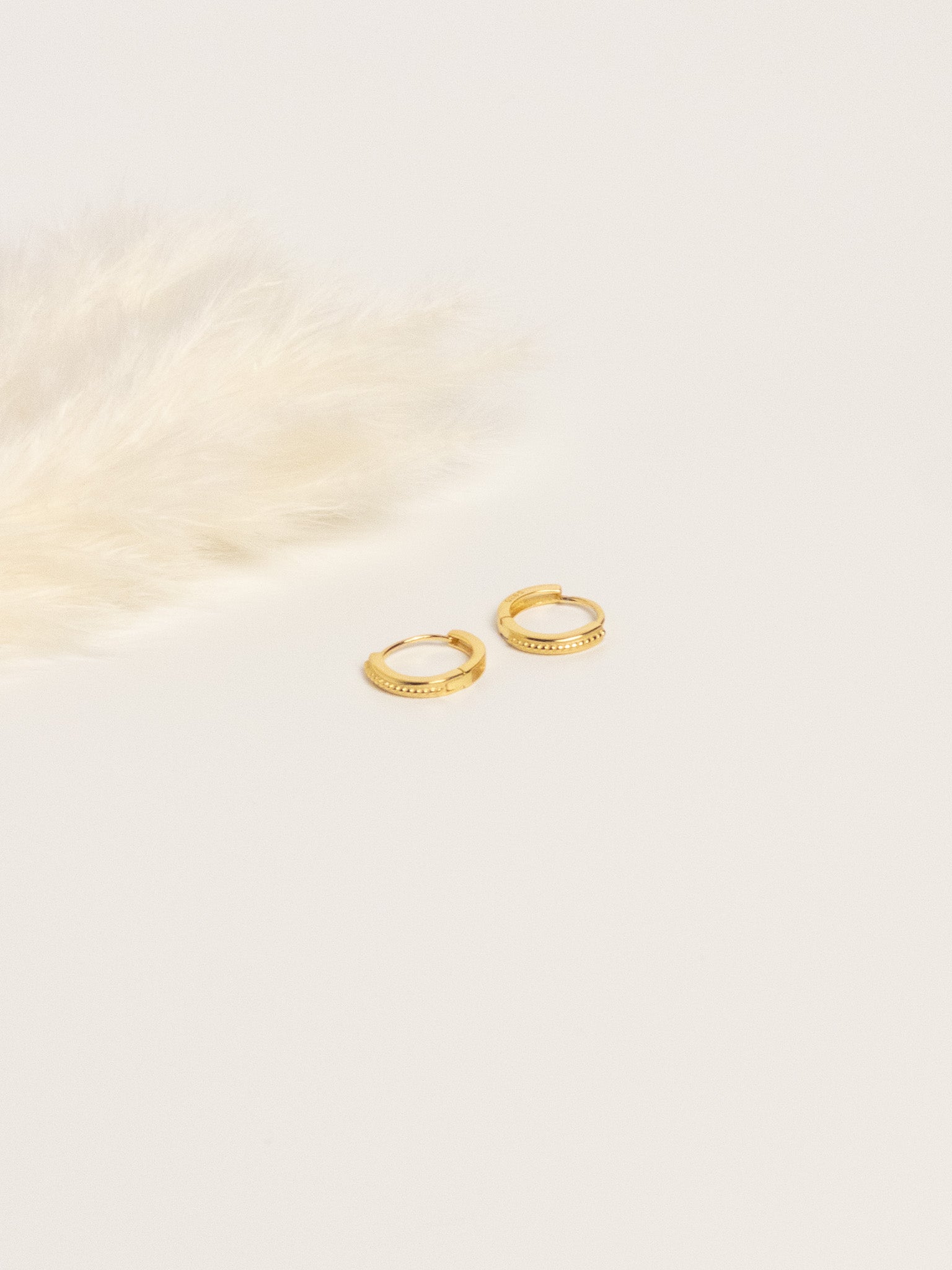 Grace Thread gold rope hoop earrings flat lay on white background