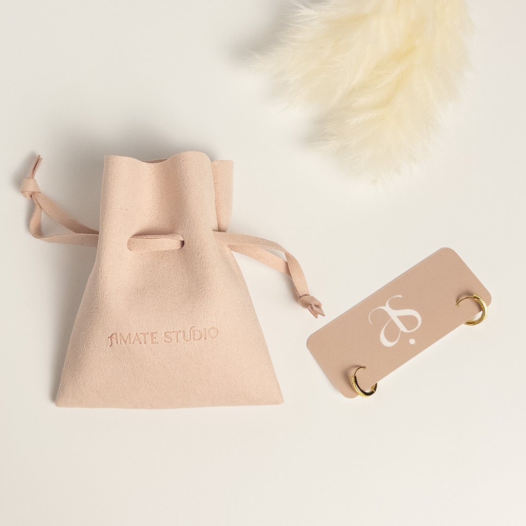 Grace Thread rope hoop earrings packaging showing earrings on display card and Amate Studio branded microfiber pouch