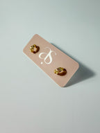 Lucía Hoop double C textured hoop earrings displayed on an earring card