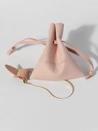 Lumen gold bracelet displayed on a jewelry tag with a matching pouch for gifting and storage.