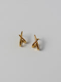 Lumen Studs gold crossover stud earrings featuring a minimalist intertwined design for everyday wear.