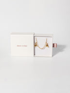 Amate Studio Lumen Studs and Lumen Chain necklace displayed in a fully opened drawer-style jewelry box, showcasing the 18k gold filled jewelry and premium packaging presentation.