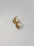 Angled view of Amate Studio Lumen Studs in 18k gold filled jewelry, showcasing the front design and partial view of the earring backing.
