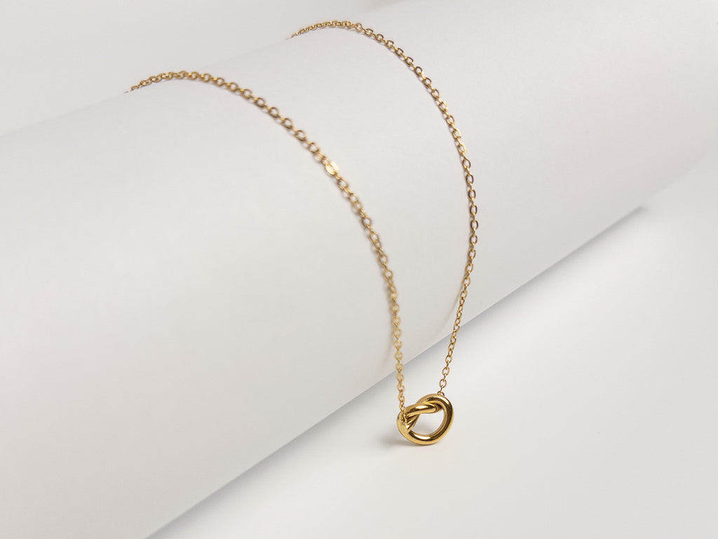 Grace Heart Necklace angled view showing gold vermeil chain and heart pendant on white surface