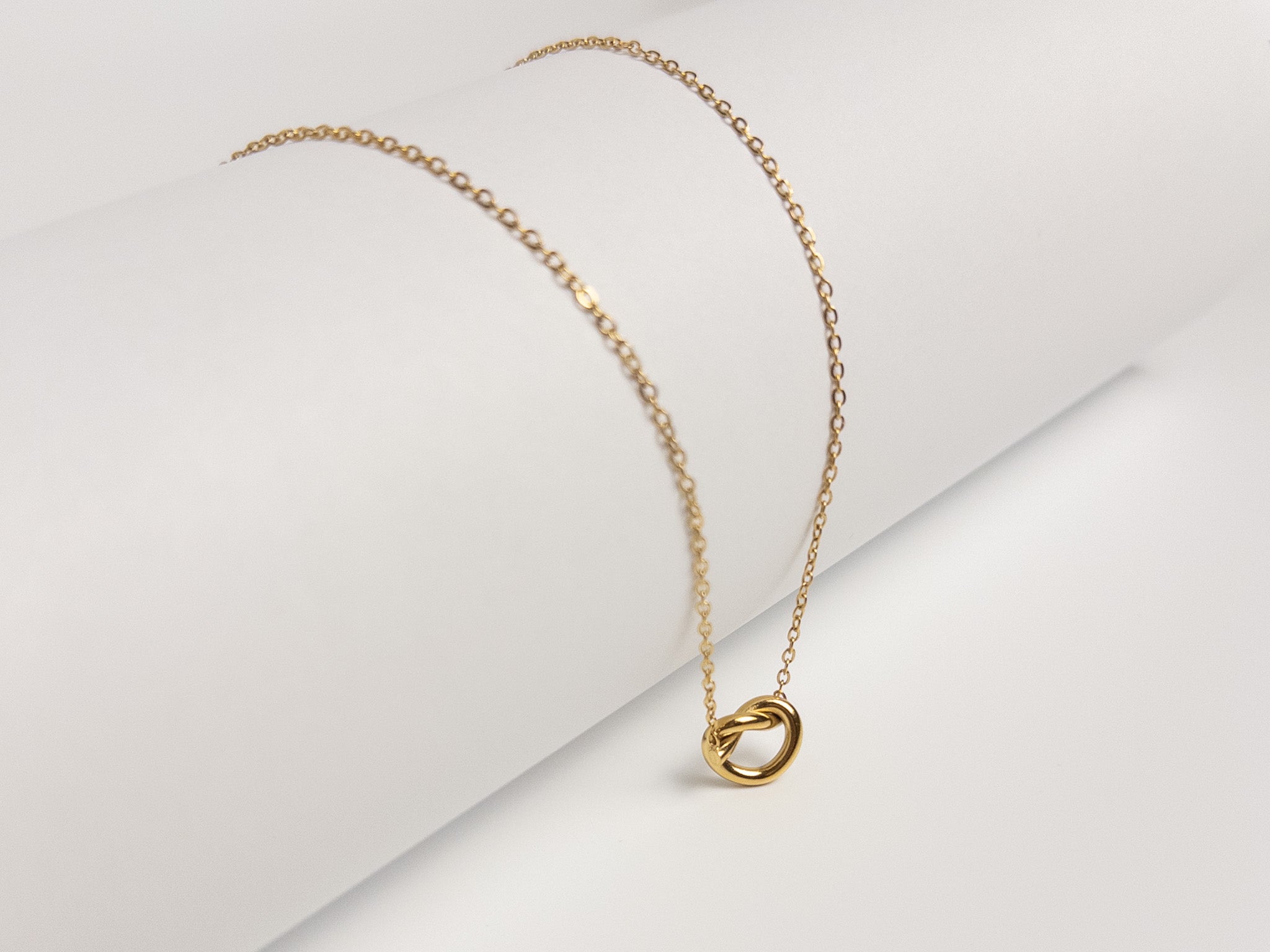 Grace Heart Necklace angled view showing gold vermeil chain and heart pendant on white surface