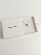 Grace Heart gold heart knot necklace inside Amate Studio drawer box with pink ribbon